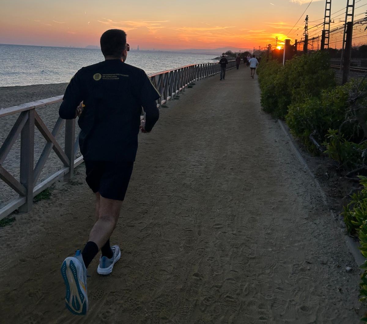 Runner on a coastal path at sunset